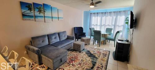 a living room with a couch and a table at Beach Access Condo with Pool, Hot Tub Area & BBQ - Gulfview I - unit 213 in South Padre Island