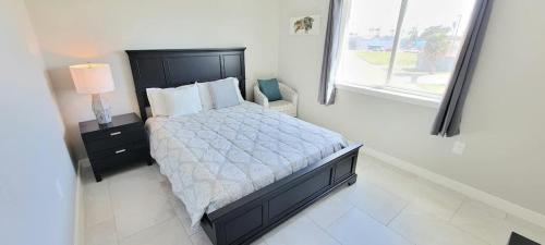 a bedroom with a large bed and a window at Bungalow Tarvana #2 home in Port Isabel