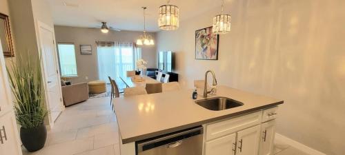 a kitchen with a sink and a living room at Bungalow Tarvana #2 home in Port Isabel