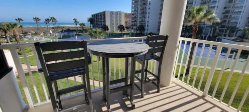 a table and two chairs on a balcony with the ocean at Beachfront Resort with Heated Pool Saida Royale 9039 in South Padre Island