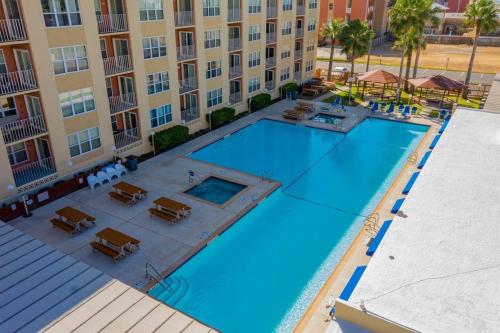 an overhead view of a swimming pool in front of a building at Great Family Condo with EZ Beach Access & SpaceX view Gulfview II #604 in South Padre Island