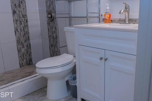 a bathroom with a white toilet and a sink at Luxe 1 Bedroom House with Pool - Gulfview II unit 410 in South Padre Island