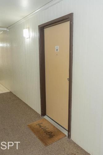 a door in a room with a sign on the floor at Luxe 1 Bedroom House with Pool - Gulfview II unit 410 in South Padre Island