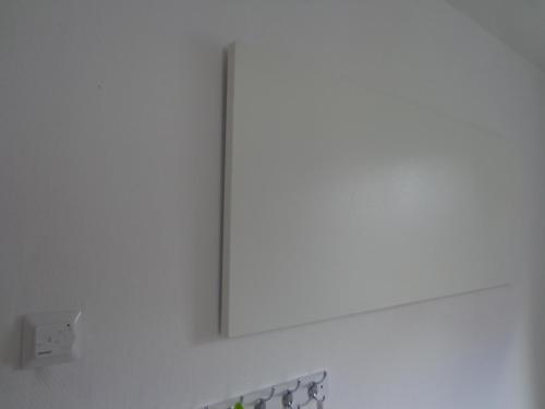 a white wall with a mirror above a sink at Ferienhaus van Wijk in Obergude