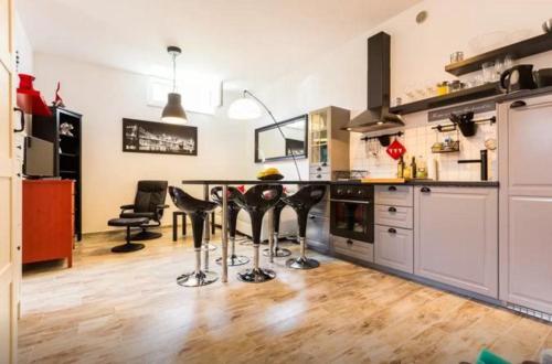 a kitchen with a table and some chairs in it at Apartment Plutus in Biograd na Moru