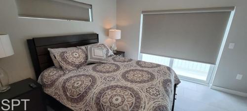 a bedroom with a bed and a television on it at New Waterfront Bungalow - Fishermans Paradise - Bungalow Tarvana in South Padre Island