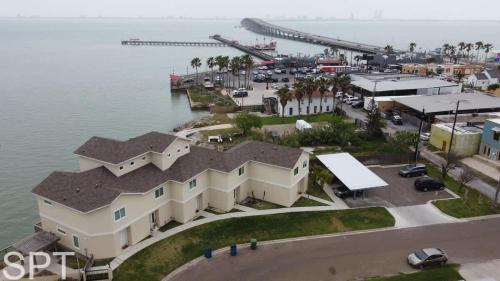 an aerial view of a building next to the water at New Waterfront Bungalow - Fishermans Paradise - Bungalow Tarvana in South Padre Island