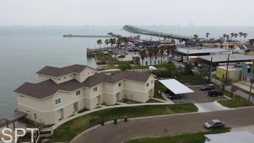 an aerial view of a house next to the water at New Waterfront Bungalow - Fishermans Paradise - Bungalow Tarvana in South Padre Island