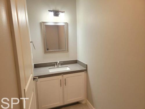 a bathroom with a sink and a mirror at New Waterfront Bungalow - Fishermans Paradise - Bungalow Tarvana in South Padre Island