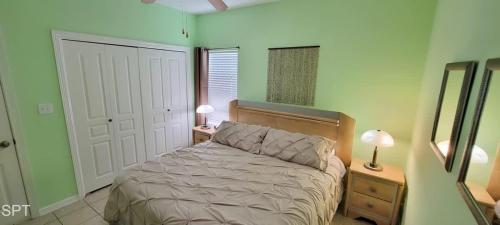 a bedroom with a bed and two lamps and a mirror at Los Cabos I #5 condo in South Padre Island