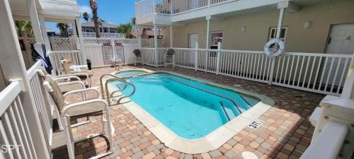 a swimming pool in the middle of a yard at Los Cabos I #5 condo in South Padre Island