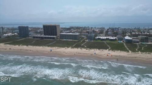 an aerial view of a beach and the ocean at Los Cabos I #5 condo in South Padre Island