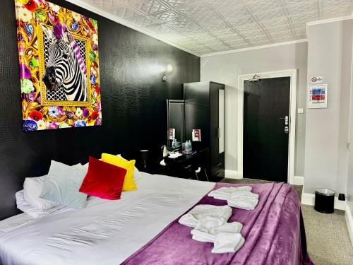 a bedroom with a large bed with towels on it at Verve Hotel in Bedford