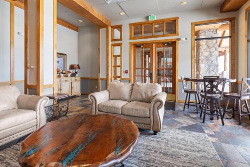 a living room with couches and a wooden table at River Run Village by Keystone Resort in Keystone