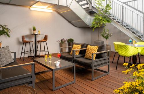 a living room with a couch and tables at NYX Hotel Prague by Leonardo Hotels in Prague
