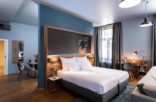 a hotel room with a bed and a couch at NYX Hotel Prague by Leonardo Hotels in Prague