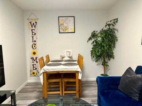 a dining room with a table and a blue couch at Global Family Canada in Calgary