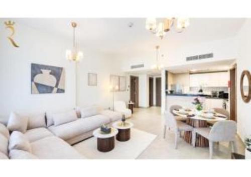a living room with a couch and a table at Vera Escape 2BR with Balcony - Relaxing Stay Near Yas Marina & Yas Mall in Abu Dhabi
