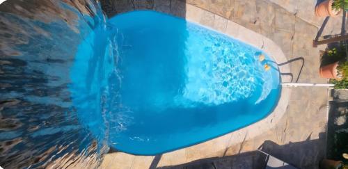 a swimming pool with a blue water slide at Discovery Beach Apartments in Aguada