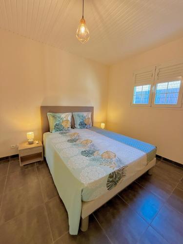 a bedroom with a large bed in a room at Villa LUGNA piscine privée in Le Vauclin