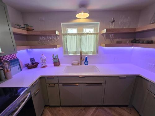 a kitchen with a white sink and a window at Salt&Sage - Modern 3BR Fully Renovated in May 2025 in Pembroke