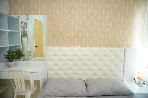 a bedroom with a bed and a desk and a mirror at Fabulous Condo Suite One Spatial Tower2 in Iloilo City