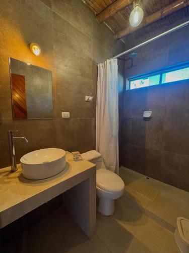 a bathroom with a sink and a toilet at Hotel Fundo El Arrabal in Ica