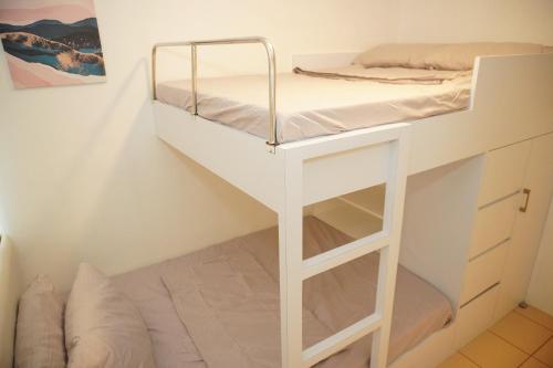 a bed in a room with a bunk bed at Fabulous Condo Suite One Spatial Tower2 in Iloilo City