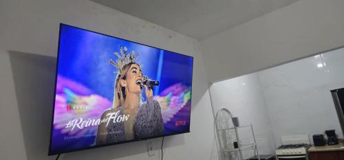 a flat screen tv hanging on a wall at Discovery Beach Apartments in Aguada