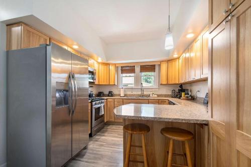 a kitchen with wooden cabinets and a stainless steel refrigerator at New Near Beach Casino Dunes Zoo& Restaurants in Michigan City