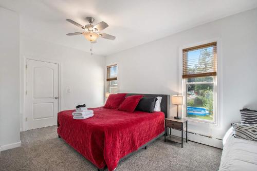 a bedroom with a red bed and a ceiling fan at New Near Beach Casino Dunes Zoo& Restaurants in Michigan City