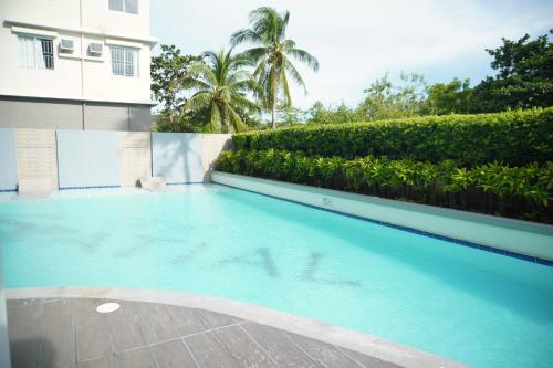 a swimming pool in front of a building at Fabulous Condo Suite One Spatial Tower2 in Iloilo City
