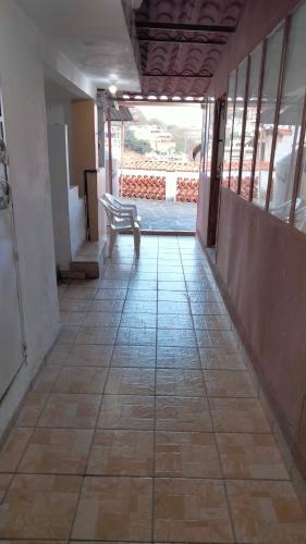 an empty hallway with a bench in a building at Casa del Patrón Posada in Taxco de Alarcón