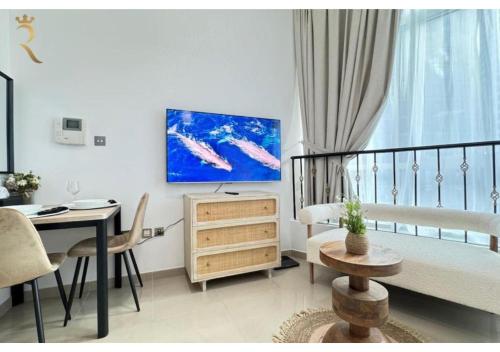 a small living room with a bed and a table at Stylish Hydra Studio -Serene City Escape in Abu Dhabi