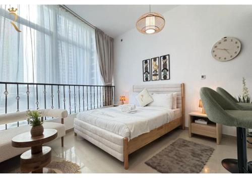 a bedroom with a bed and a clock on the wall at Stylish Hydra Studio -Serene City Escape in Abu Dhabi