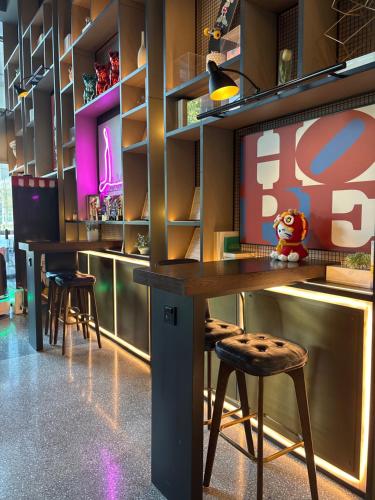 a bar with stools and a table with a stuffed animal at Wanda Grand Hotel, Nanjing South Railway Station in Nanjing