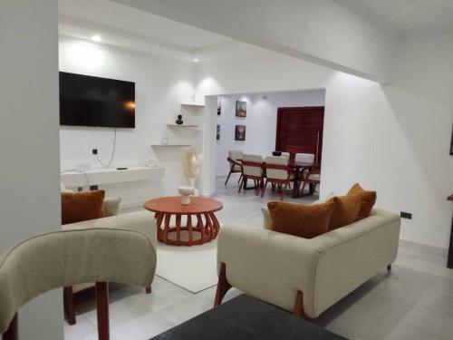 a living room with a couch and a table at Secret Oasis in Lusaka