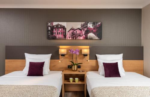 Un ou plusieurs lits dans un hébergement de l'établissement Leonardo Hotel Düsseldorf Airport Ratingen