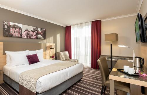 Un ou plusieurs lits dans un hébergement de l'établissement Leonardo Hotel Düsseldorf Airport Ratingen