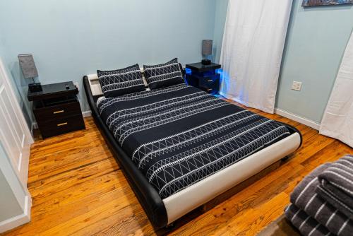 a bed with two pillows on it in a room at Hells Kitchen Hideaway in New York