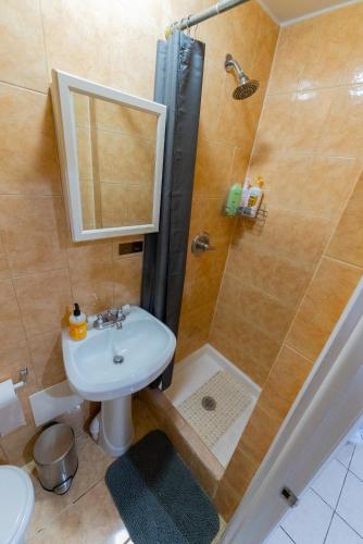a bathroom with a shower and a sink and a toilet at Hells Kitchen Hideaway in New York