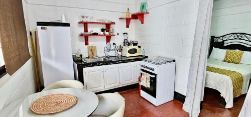 a small kitchen with a sink and a table at Apartamento Mirador de La ciudad in Jarabacoa