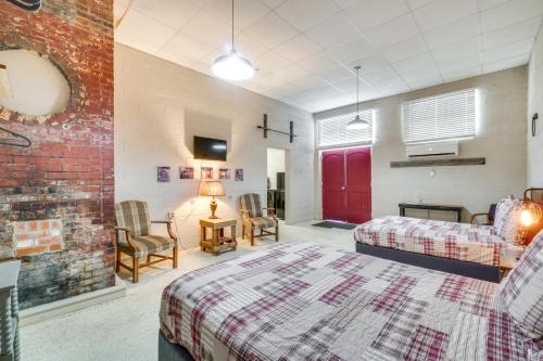 a bedroom with a bed and a brick wall at The Boiler Room - ATV-Friendly Briceville Gem! in Briceville