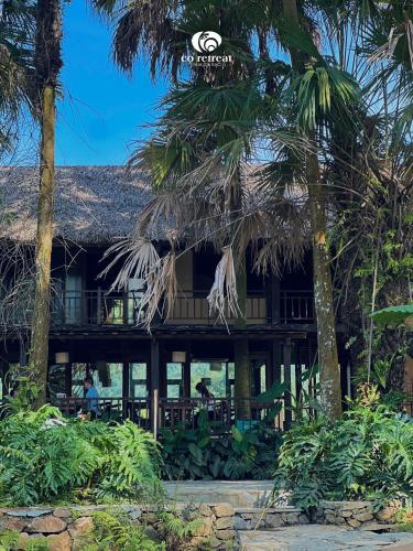 a resort on the beach with palm trees at Cọ Retreat Da Bac in Hòa Bình