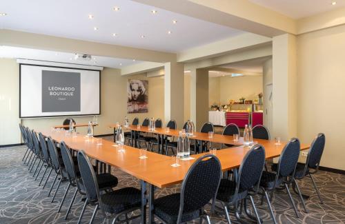 a large conference room with a long table and chairs at Leonardo Boutique Hotel Berlin City South in Berlin