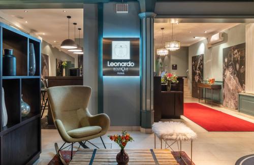 a store with a chair and a red rug at Leonardo Boutique Hotel Berlin City South in Berlin