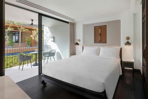 a hotel room with a bed and a balcony at Marriott Vacation Club, Khao Lak Beach Resort in Khao Lak