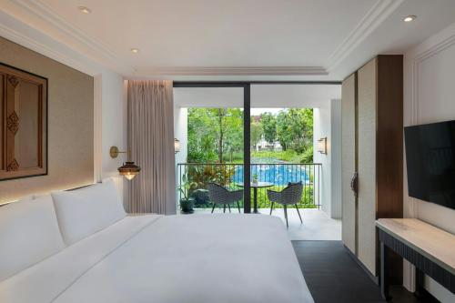 a bedroom with a large white bed and a balcony at Marriott Vacation Club, Khao Lak Beach Resort in Khao Lak