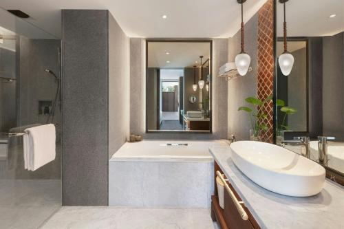 a bathroom with a large tub and a sink at Marriott Vacation Club, Khao Lak Beach Resort in Khao Lak