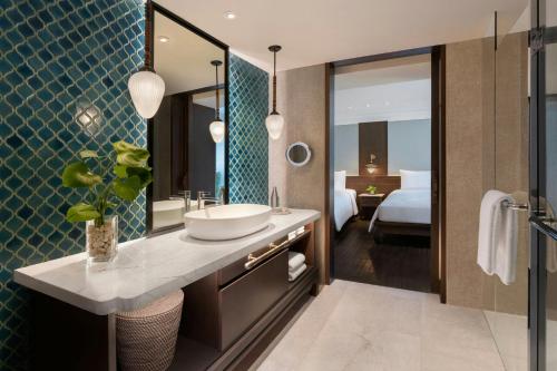 a bathroom with a sink and a mirror at Marriott Vacation Club, Khao Lak Beach Resort in Khao Lak
